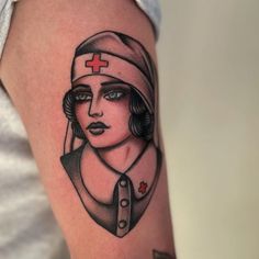 a woman with a red cross tattoo on her arm