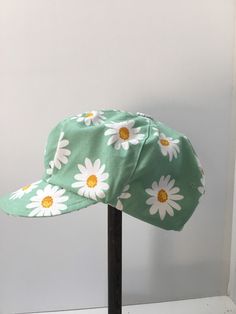 "Womens newsboy, slouchy cap has been sewn from a fresh green white daisy print. The cap is fully lined , with a topstitched brim or peak. The six panels have been finished with a hand made button. This is a bright summer casual cap.. pop it on to go shopping, wear on the weekend with jeans or take on holiday.... Foldable and washable.... (the fabric has been  prewashed) There is an elastic cord for adjusting. Please check your head measurements with those below. A comfy and soft cap which sits Vintage White Baseball Cap For Summer, Green Flat Cap For Summer, Green Summer Flat Cap, Vintage Cotton Baseball Cap For Summer, Retro Visor Baseball Cap For Spring, Vintage Visor Baseball Cap For Summer, Retro Cotton Summer Baseball Cap, Retro Summer Cotton Baseball Cap, Cotton Flat Cap For Summer