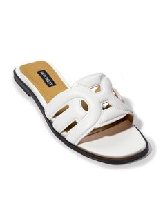 Simply slip on this comfy slide sandal and go, with its flat heel, lightly padded sole, and stylish faux leather upper. Perfect for pairing with your favorite bottoms or a chic sundress. This versatile shoe is a wardrobe must-have in neutral to colorful hues. White Slip-on Flats For Vacation, Synthetic Slip-on Slides For Day Out, Slide Flats For Spring Vacation, Trendy White Leather Slides, White Cushioned Flats For Summer, Chic Slip-on Slides For The Beach, Chic Flat Slides With Textured Footbed, Chic Slide Slippers For Vacation, Chic Synthetic Flat Slides