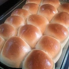 bread rolls sitting on top of a pan in the oven