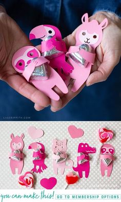 someone is holding up some pink paper cut outs with hearts and animals on them for valentine's day