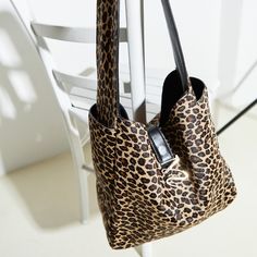 This shoulder bag boasts a comfortable strap for effortless carrying. It features an easy-access front pocket and a zipped pocket inside for secure storage of your essentials. The closure with a magnetic button ensures your belongings remain safe and secure.  This stylish bag is crafted from 100% calfskin leather, showcasing a luxurious leopard print exterior. The gold-plated logo adds a touch of elegance, while the feet at the bottom protect the bag from scratches and scuffs. 100% Calf Leather Stocking Fillers For Her, Forever Jewelry, Holiday Party Outfit, Brown Leopard, Jewelry Ring Box, Stylish Bag, Women Accessories Bags, Gifts For Mum, Womens Jewelry Rings