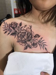 a woman with a flower tattoo on her chest