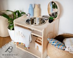 a wooden sink and mirror in a room with potted plants on the floor next to it