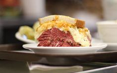 a sandwich on a white plate sitting on top of a counter