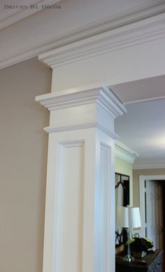 an image of a room with white trimming on the walls and around the pillars