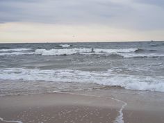 the waves are coming in to the beach and it looks like they're getting wet