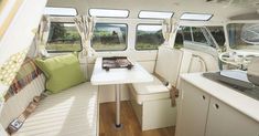 the inside of a camper with white walls and wood flooring is shown in this image