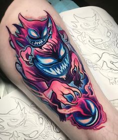 a colorful tattoo on the leg of a person's leg with an image of a demon