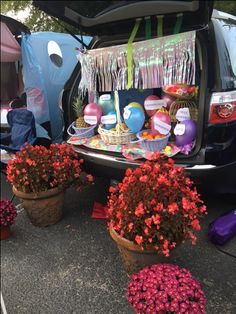 the trunk of a car is filled with flowers and other things to decorate for someone's birthday