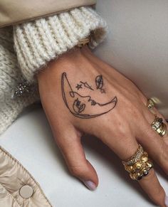 a woman's hand with a tattoo on it