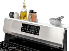 an oven with spices, salt and pepper shakers on it