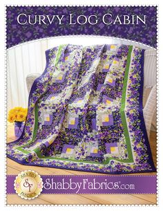 a purple and green quilt with flowers on it