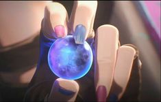 a woman with pink and blue nail polish holding a crystal ball in her right hand