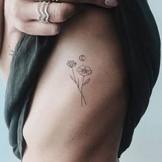 a woman's arm with a flower tattoo on the left side of her body