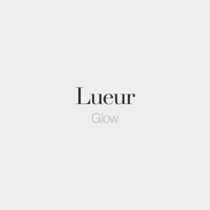 the word lueur glow in black and white on a light gray background with an image of