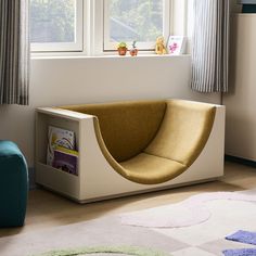 a modern daybed in the corner of a room with two large windows and colorful rugs on the floor