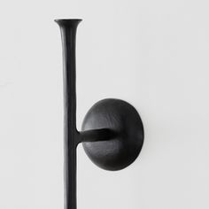 a black door handle on a white wall