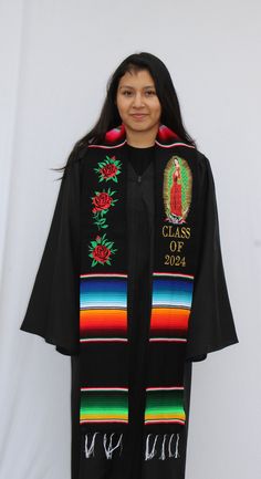 Show off your culture and roots during your graduation with our handcrafted sashes/stoles. This Virgin Mary stole includes embroidered Virgin Mary image on one side plus CLASS OF 2024 embroidery and embroidered roses on the other side. CONGRATULATIONS CLASS OF 2024! Material: Mexican Sarape Textile Measurements: Length: 7 feet Width: 5 inches Traditional Embroidered Graduation Stole, Embroidered Black Graduation Stole, Multicolor Embroidered Graduation Stole, Embroidered Multicolor Graduation Stole, Mexican Sarape, Graduation Sash, Images Of Mary, Embroidered Roses, Class Of 2024