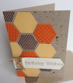 a birthday card with an orange and brown hexagonal design