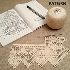 an open book with crochet on it next to a ball of yarn and a pair of scissors