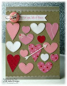 a handmade card with lots of hearts and a needle in the middle, on top of a table