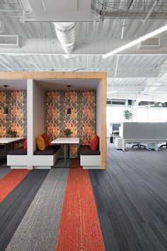 an empty office with colorful carpeting and white booths in the middle of the room