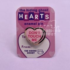 a pink heart shaped pin with the words hearts on it