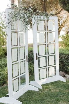 an outdoor ceremony area with mirrors and greenery