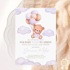 a baby shower card with a teddy bear holding balloons in the sky, on top of a white plate