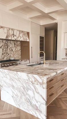 a large kitchen with marble counter tops and wooden flooring in the middle of it