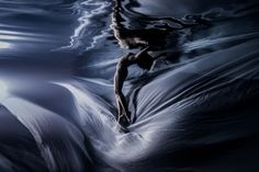 an artistic photo of a woman floating in the water