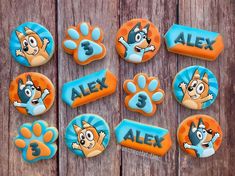 cookies with cartoon characters on them sitting on a wooden table next to the words alex