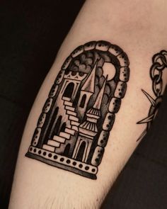 a man's arm with a castle in the middle and a crown on it