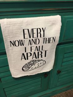 a tea towel hanging on the side of a green cabinet that says, every now and then i fail apart