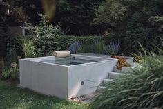 an outdoor hot tub in the middle of a garden