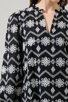 This top will set the vibe for the day or night! How cute is this white eyelet design on a black background. Long sleeves followed with cuffs at the end are followed by a split neckline with ruffles on the shoulders and around the neck. Wear it with match jeans and some black heels. - Split neck- Ruffle trim- Balloon sleeves- Lined- Color: Black IvorySize + Fit - Model is 5'8" and wearing size XS- Measurements taken from size S - Chest: 19 1/2"- Length: 25 1/2" Fabric Self:100% Cotton, Lining:97 Eyelet Top, White Eyelet, The Vibe, Neck Ruffle, Puff Sleeve Top, Balloon Sleeves, Ruffle Trim, Black Heels, Black Background