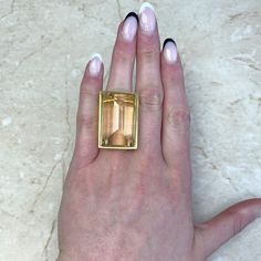 A stunning vintage citrine cocktail ring set in a beautiful Retro 18k yellow gold mounting. This mid-century ring is artfully sculpted with graduated concentric lines that lead to the citrine.
Circa 1940.
If you have any questions about this ring, please feel free to contact us. Modern Gold Topaz Ring In Rectangular Shape, Modern Gold Rectangular Topaz Ring, Art Deco Gold Topaz Ring, Art Deco Gold Topaz Gemstone Ring, Gold Art Deco Topaz Gemstone Ring, Art Deco Gold Topaz Ring Collectible, Gold Art Deco Topaz Ring Collectible, Art Deco Yellow Gold Topaz Ring, Art Deco Citrine Topaz Ring For Formal Occasions