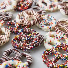 there are many donuts with chocolate and sprinkles on them