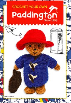 a crocheted teddy bear wearing a red hat and blue shirt