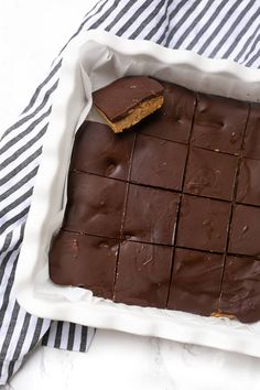 a pan filled with chocolate squares on top of a table