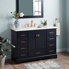 a bathroom vanity with two sinks and a large mirror above it, along with a rug on the floor