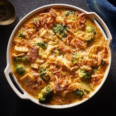 a casserole dish with broccoli and meat in it on a table