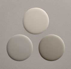 three white circles on a gray background