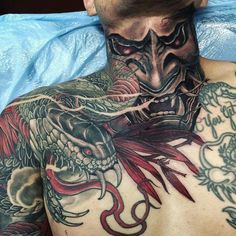 a man with tattoos on his neck and chest