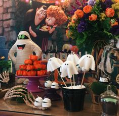 a table topped with halloween treats and decorations