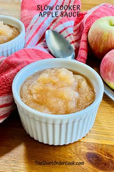 two bowls filled with apple sauce on top of a wooden table