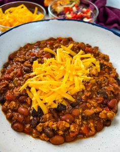 a white plate topped with chili and cheese