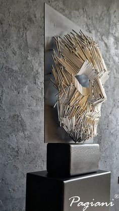 the sculpture is made out of sticks and metal