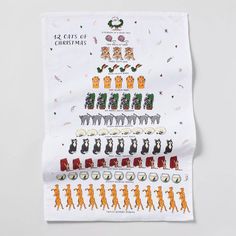 a white tea towel with an illustrated christmas tree